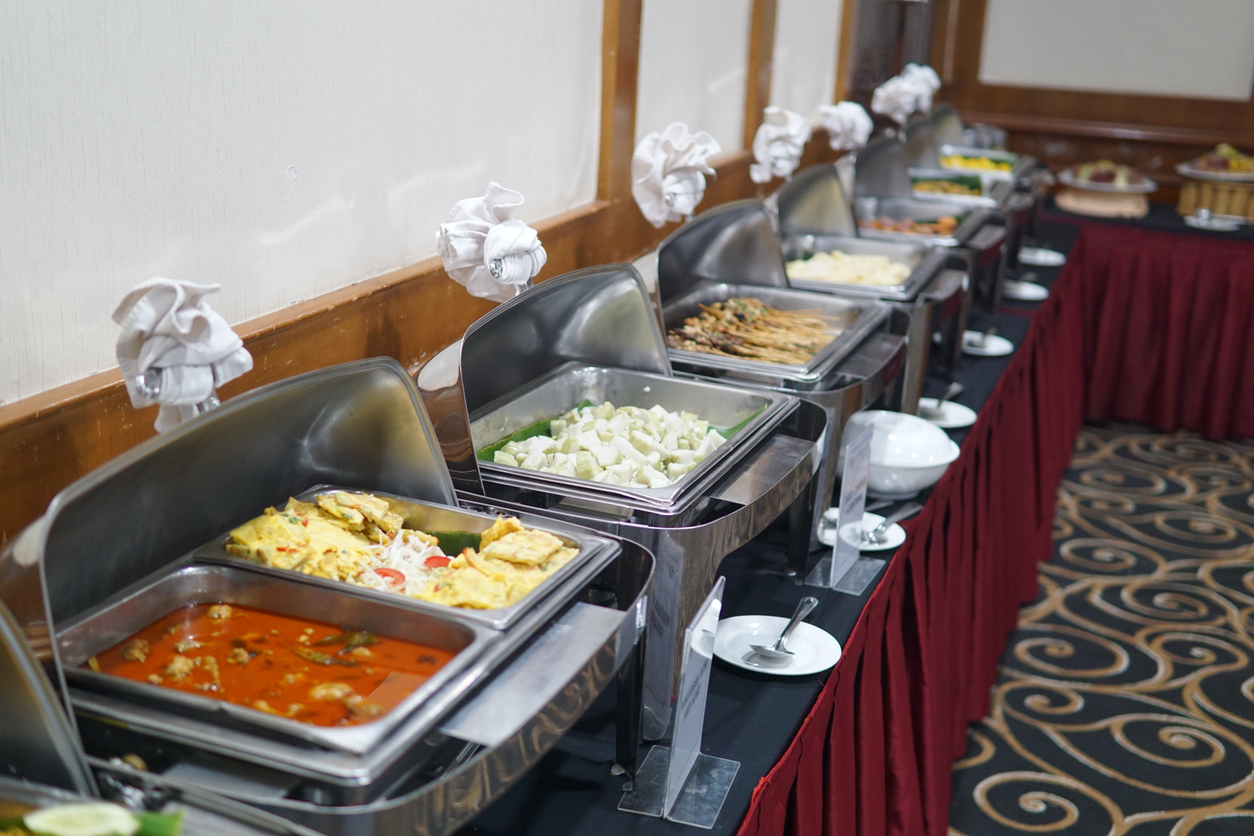 A lined up catered buffet is prepared for incoming guests.