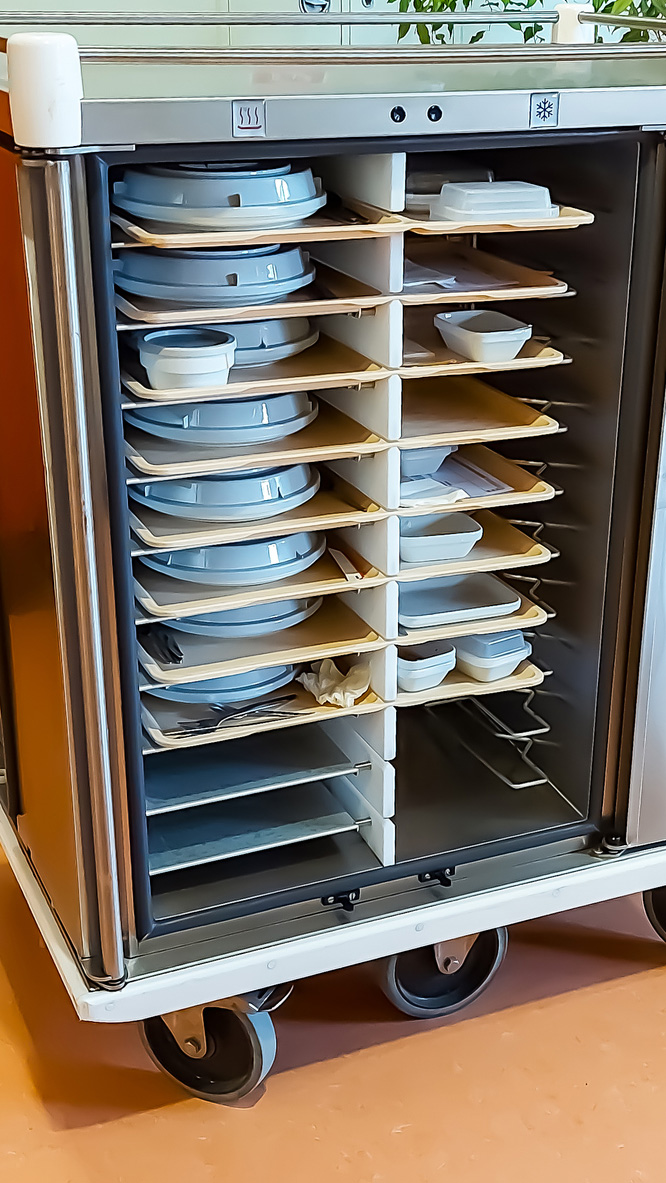 Trolley for transporting food on trays in hospital